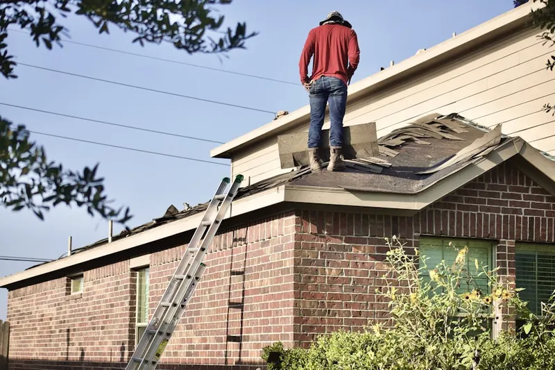 Professional roofer working on a residential roof in Patuxent Riding